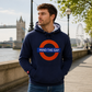 Man wearing a navy hoodie with a 'Mind the Gap' design in London.