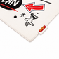A close-up of a white textured fabric item, likely a baby blanket or play mat, featuring a black cartoon bear wearing sunglasses, a red arrow graphic, and a small red brand tag reading 'MIRACOL'.