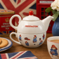 Official Paddington Bear Tea-for-One ceramic teapot and cup set displayed in a cosy British-inspired tea setting with biscuits, English Breakfast tea and classic London décor.