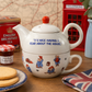 Official Paddington Bear Tea-for-One teapot and cup set styled in a traditional British afternoon tea scene with Union Jack accents and classic tea-time accessories.