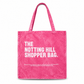 Pink tote bag with 'The Notting Hill Shopper Bag' text on a white background