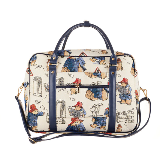 Rear view of the cream Paddington Bear print laptop bag with navy handles, shoulder strap, trolley sleeve and zip pocket.