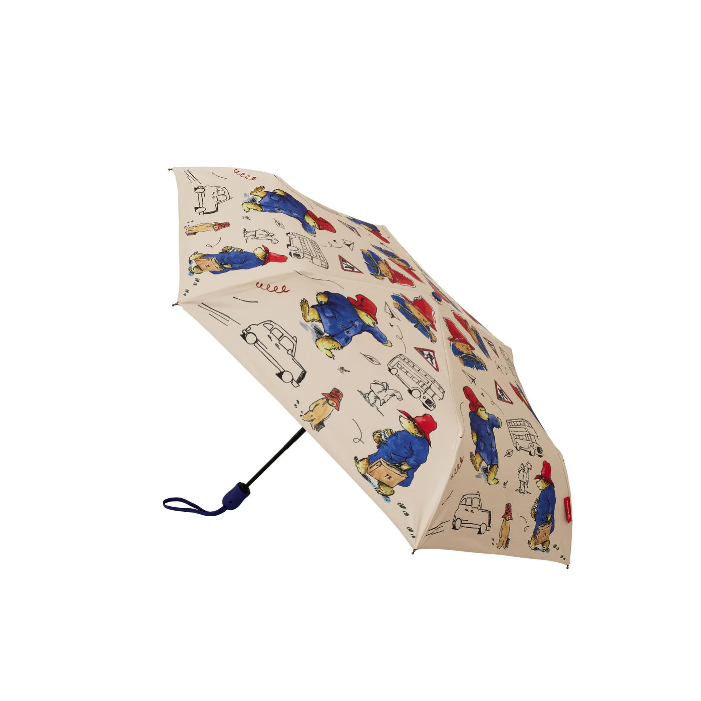 Open cream Paddington Bear print umbrella shown from the side, with a black shaft and navy wrist strap.
