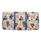 Bottom view of the cream Paddington Bear print travel bag with navy reinforcement straps and protective metal feet.